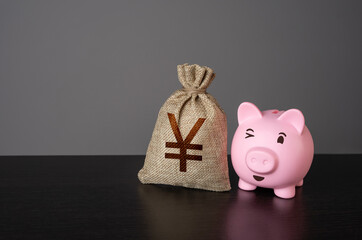 Winking piggy bank and yen or yuan money bag. Deposits and savings. Loans and credits, mortgage....