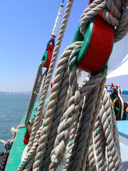 Detail of ancient pulleys and ropes or cords on the prow or bow of the sailboat Amoroso, a historical, typical or traditional Varino type Tagus river estuary boat. Pulley without wheel. Tagus river 