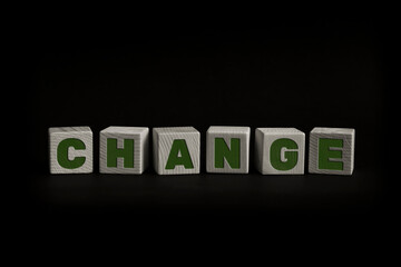 Word CHANGE written with wooden cubes. Studio shot of some arranged wooden blocks with a textual...