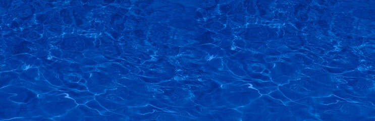 Transparent blue colored clear water surface texture with splashes.  Water background, ripple and...
