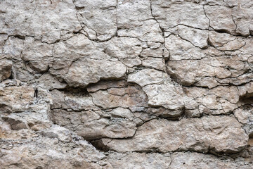 Rough gray rock wall, natural stone background texture