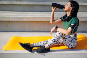 Athletic Woman Taking a Water Break at the Stadium