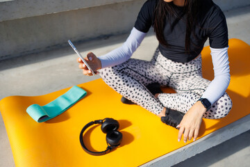 Athletic Woman on Yoga Mat Checking Phone