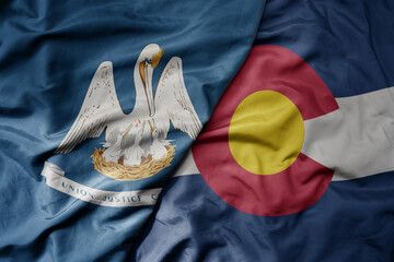 big waving colorful national flag of colorado state and flag of louisiana state .