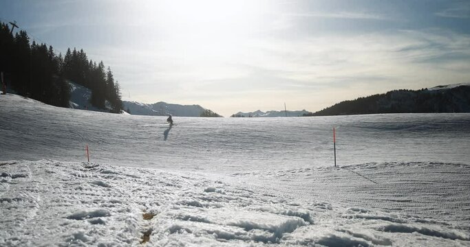 Family skiing in alps mountains on sunny day - Skier riding down on winter time - Snow sport training and vacation concept
