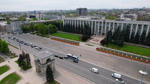 Panoramic aerial drone view of Triumphal Arch, Great National Assembly Square with Government Building of Republic of Moldova on background in Boulevard Stefan cel Mare of Chisinau, Moldova. 4K video.