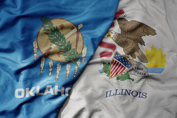 big waving colorful national flag of illinois state and flag of oklahoma state .