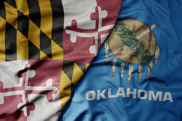 big waving colorful national flag of oklahoma state and flag of maryland state .