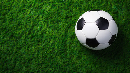 soccer ball on a green grass field playground background with copy space, top view