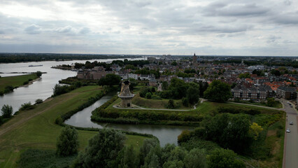 Fototapeta premium Dutch Delight: Gorinchem's Charming Townscape Accentuated by Majestic Windmill