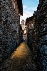 Old alley in an Italian village of Lake Como at sunset