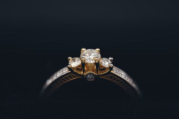 Vintage Gold Diamond Cluster Ring Against a Black Background