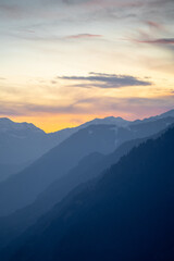 Fototapeta premium Orange blue hues of Himalaya mountains from shimla showing the serenity of this popular tourist destination at sunset