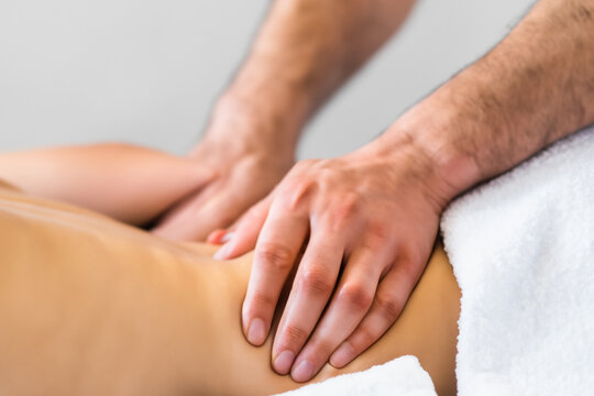 massage parlor services. The masseur gives his client a massage, hands and body close-up. relaxation and recovery concept