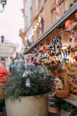 Cute shops with Christmas toys and decorations at the New Year city fair. Wooden house with lots of gifts. Christmas trinkets. New Year's crafts