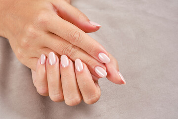 Care for sensuality female hands with pink nails. New artificial fingernails of adult woman. Art...