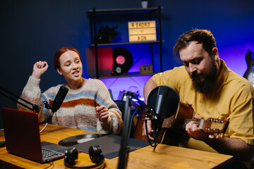 The presenter and the guest perform the song during the radio broadcast. Concept of online entertainment and blogging.