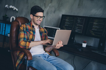 Portrait of smart happy web designer guy sitting chair use wireless netbook coworking modern office...