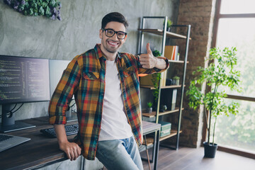 Portrait of cheerful successful corporate agent sit desk hand finger demonstrate thumb up...