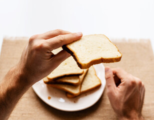Slice of sandwich bread in male hand.
