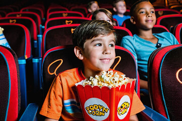 Children eating popcorn and watching a movie at the cinema. Generative AI