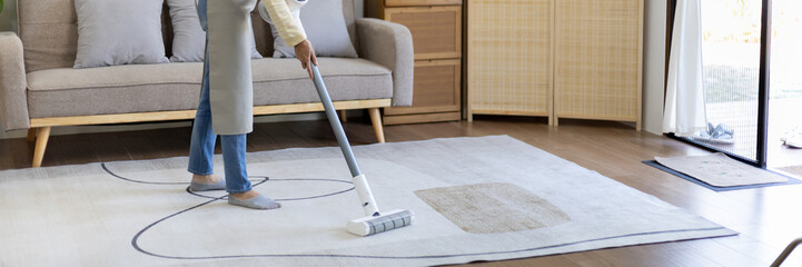 Beautiful woman vacuuming the floor and carpet in her living room, Big cleaning in the house,...