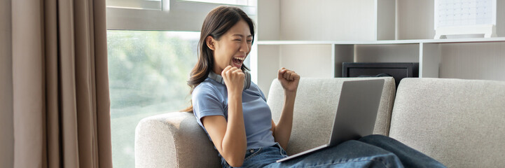 Woman playing games on laptop, Rejoices in victory, Female enjoying playing online games,...