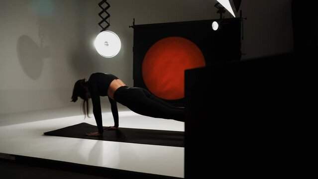 Athletic woman doing yoga in a photo studio. Yoga and meditation concept. 4k