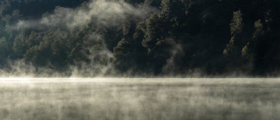 Fog over the mountain lake