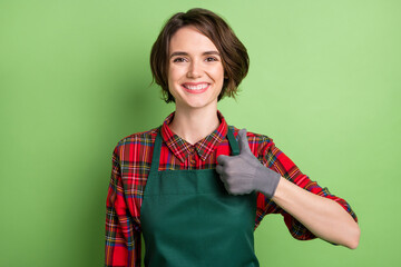 Portrait of pretty cheerful lady show thumb up have good mood look camera isolated on green color...