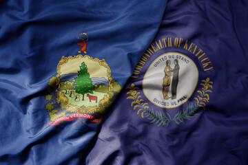 big waving colorful national flag of kentucky state and flag of vermont state .
