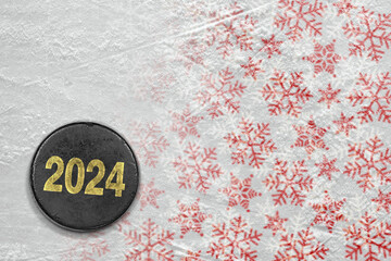 Fragment of an ice arena with a winter pattern and a hockey puck