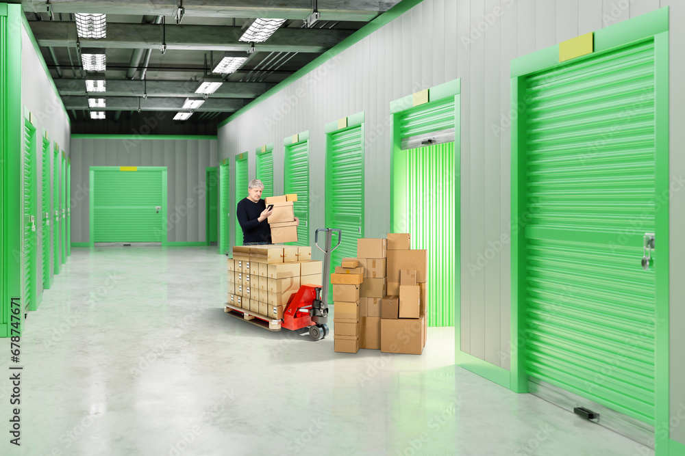Poster man rents storage unit. warehouse with gates to containers for safekeeping. cardboard boxes near sto