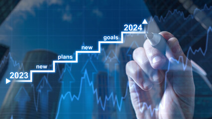 Business strategy. Growth graph on virtual screen. Businessman hand draws staircase. Goal for 2024...