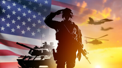 US armed forces. American army soldier. Fighter with US flag at sunset. Tanks and planes near...