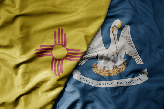 big waving colorful national flag of louisiana state and flag of new mexico state .