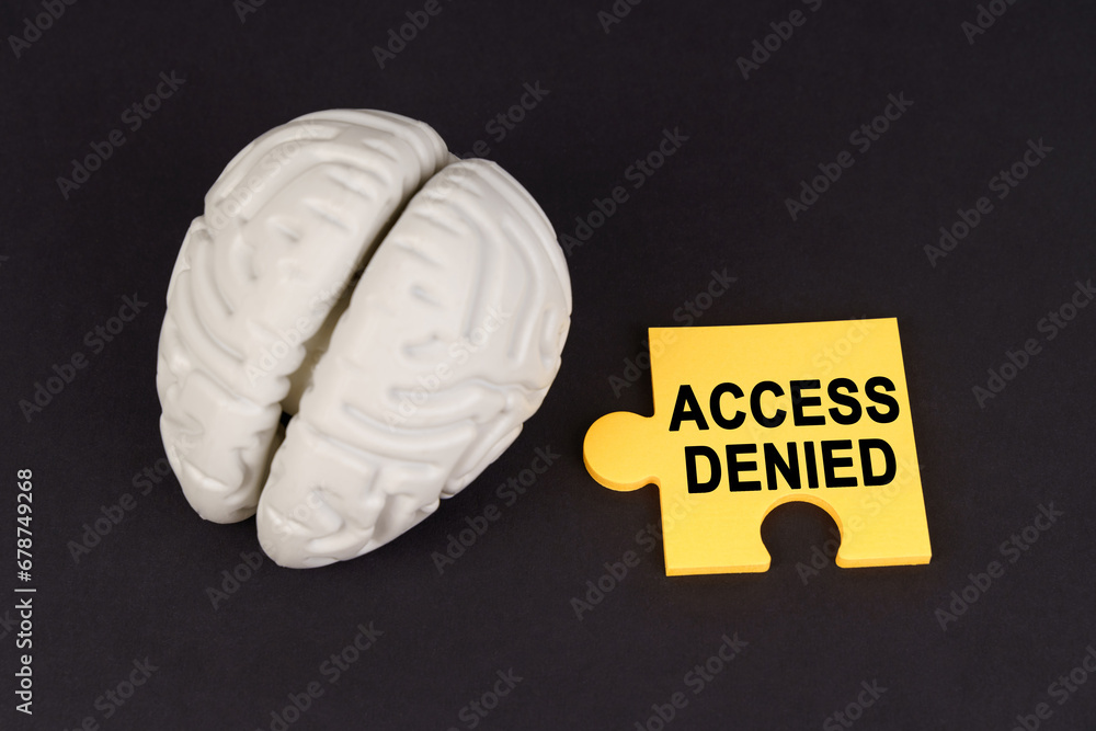 Aufkleber On a black surface lies a brain and a yellow puzzle with the inscription - access denied