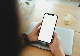 Close up of woman using cell phone,sending massages on the coffee shop.having sunbath.Phone with black screen,texting,video calls,