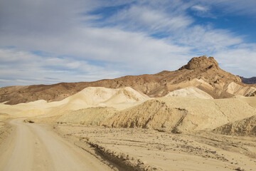 Fototapeta na wymiar Gravel road through 20 Mule Team Canyon at Death Valley National Park, California