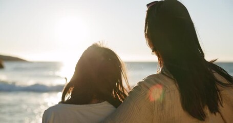 Child, hug and beach with back, parent and care on vacation by the sea with freedom. Embrace, young kid and girl with mother and happy family with holiday and mom together on adventure at sunset