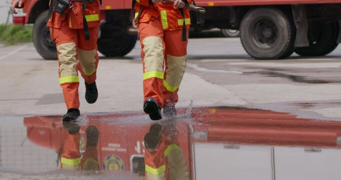 A special team of firefighters seizes hoses from a firetruck and embarks on a perilous mission to extinguish a blazing fire, showcasing their bravery and professional expertise in tackling a hazardous