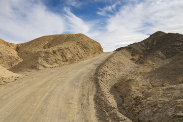 Fototapeta na wymiar Gravel road through 20 Mule Team Canyon at Death Valley National Park, California