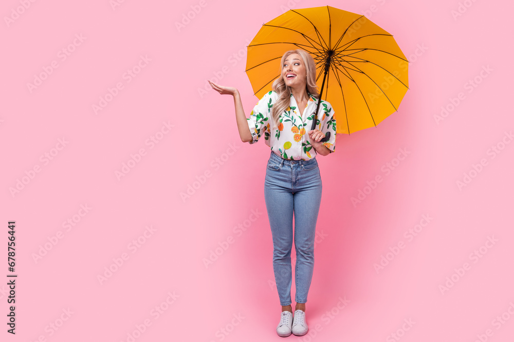 Poster full length body photo of funny young woman holding arm protect herself rainstorm weather check drop