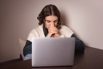 Worried woman sitting with laptop, feel fear anxiety. girl stressed, making hard decision