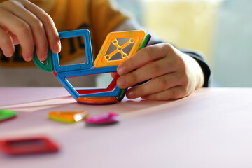 Children pens with magnetic geometric constructor on pink background. everyday children games, children leisure.