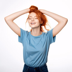 A jubilant redheaded gal, clad in blue and jeans, effervescently dancing with arms upraised and closed eyes on a white backdrop.