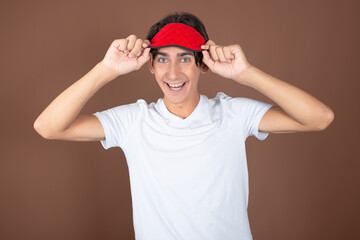 Funny attractive guy posing on a brown background.