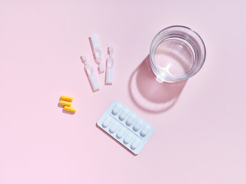 Flat lay creative composition with food supplement pills on colorful background