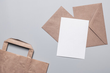 Two craft envelopes, a blank form and a craft bag on a gray background. Holiday shopping and gift...