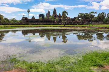 Fototapeta na wymiar Angkor Wat Temple Complex reflected in the lake at Midday - UNESCO World Heritage 12th century masterpiece of Khmer Architecture built by Suryavarman II at Siem Reap, Cambodia, Asia